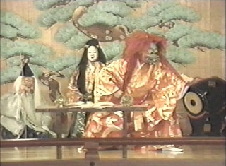 Ashi-nadzu-te-nadzu (left) and his daughter, Princess Kushinada, watch as the Orochi Dragon drinks.